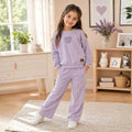 Girl wearing a lavender sweatshirt with matching wide-leg pants 