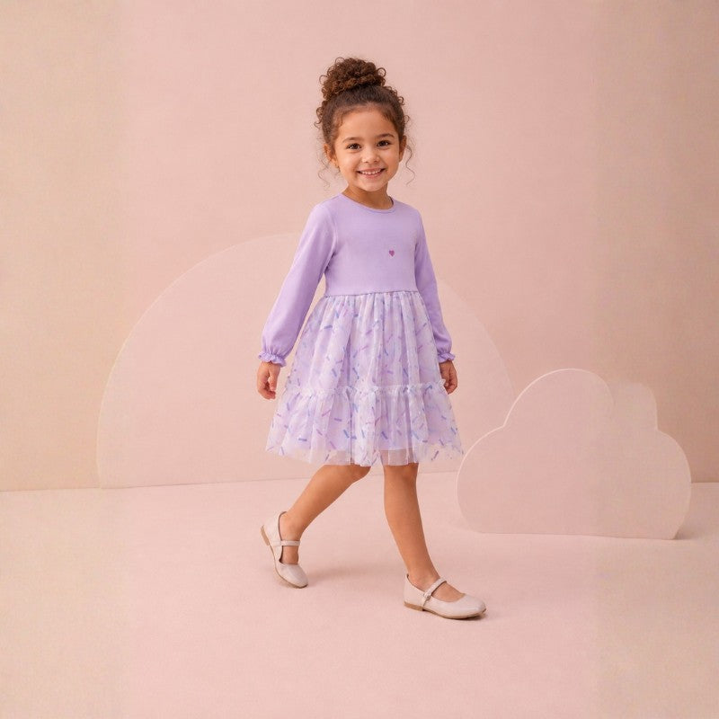 Girl wearing a long-sleeve dress with floral tulle skirt 