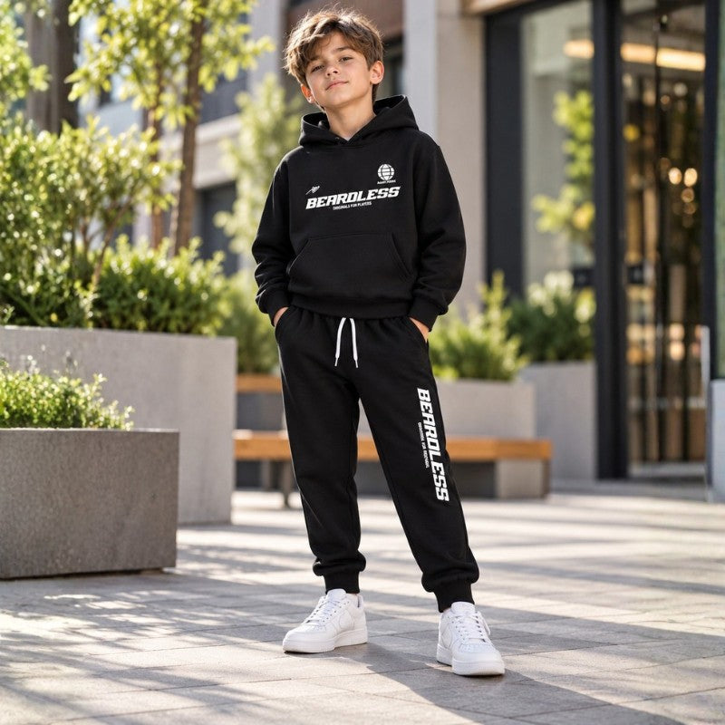 Young boy wearing a black kids fleece hoodie and matching jogger pants set 