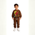 Smiling young boy wearing a brown racing car tracksuit 