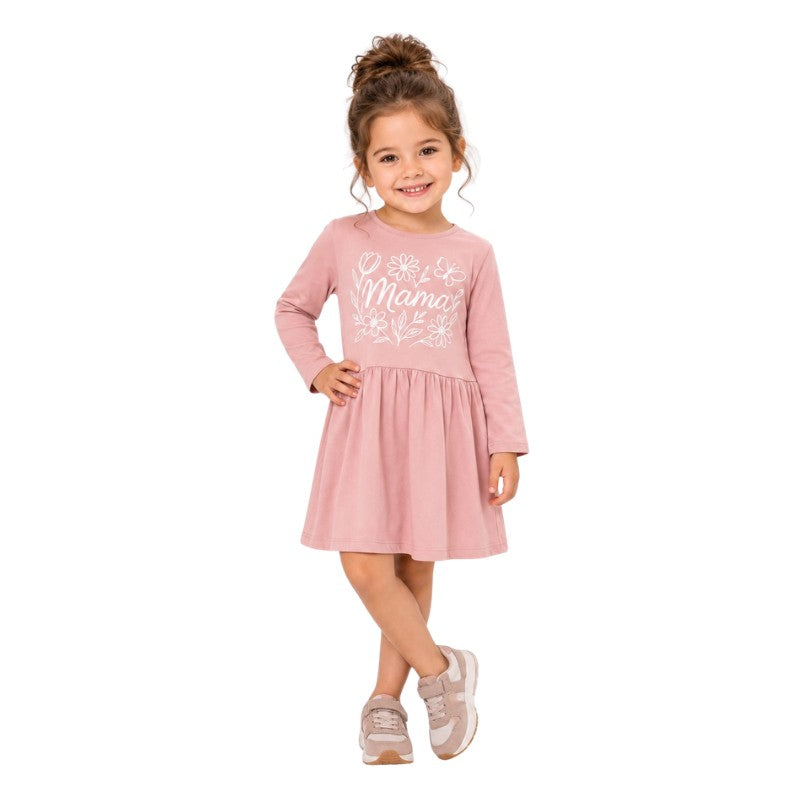 Smiling young girl wearing a long sleeve dress with a white floral graphic print 