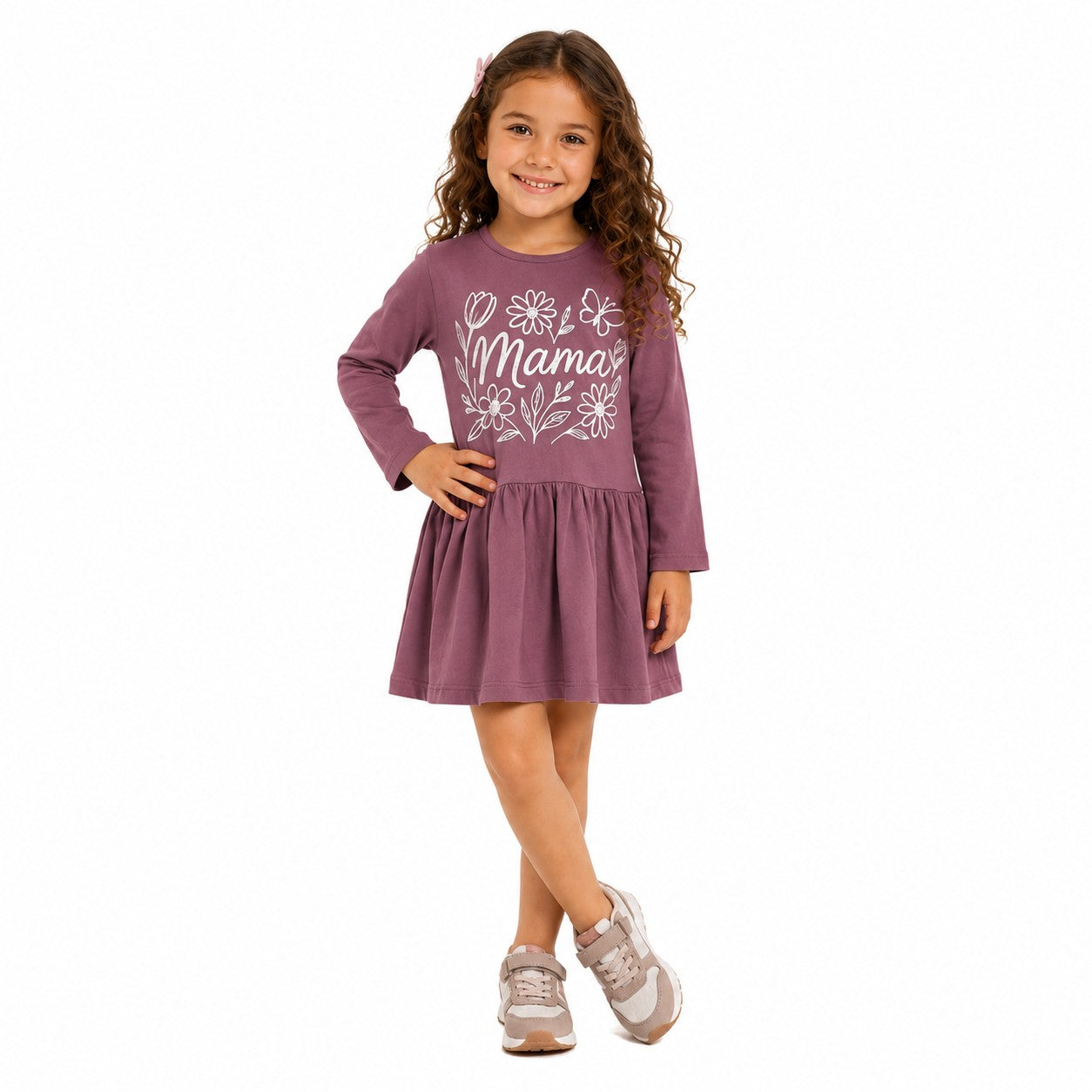 Smiling young girl wearing a long sleeve dress with a white floral graphic print 