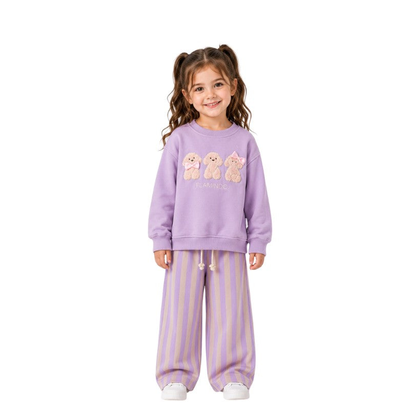 Young girl wearing a teddy bear sweatshirt with striped pants 