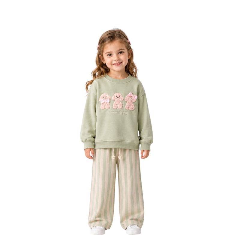 Young girl wearing a teddy bear sweatshirt with striped pants 