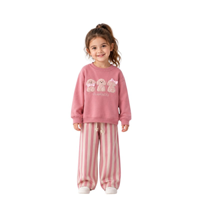Young girl wearing a teddy bear sweatshirt with striped pants 