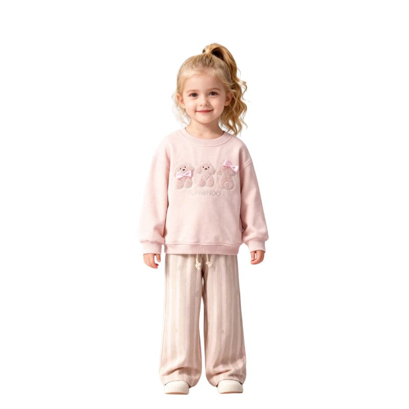 Young girl wearing a teddy bear sweatshirt with striped pants 