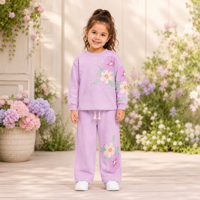 Young girl wearing a floral tracksuit set
