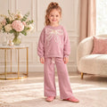 Girl wearing a pink bow sweatshirt with matching wide-leg pants