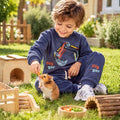 Happy child wearing a comfortable navy blue kids’ sweatshirt and joggers set while playing outdoors 