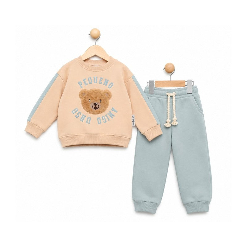 Beige teddy bear sweatshirt with light blue sleeve accents and matching light blue joggers