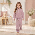 Girl wearing a fleece half-zip sweatshirt and matching pants with tulip details