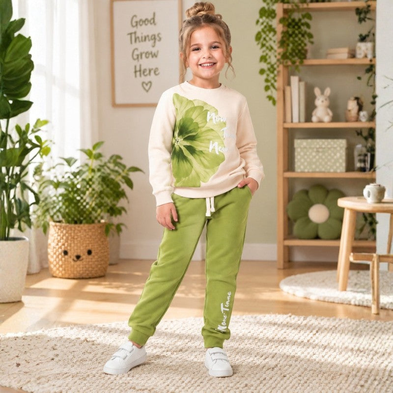 Young girl wearing a cream sweatshirt with floral print and matching jogger pants for kids