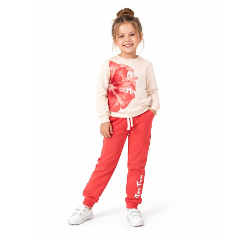 Young girl wearing a cream sweatshirt with floral print and matching jogger pants for kids