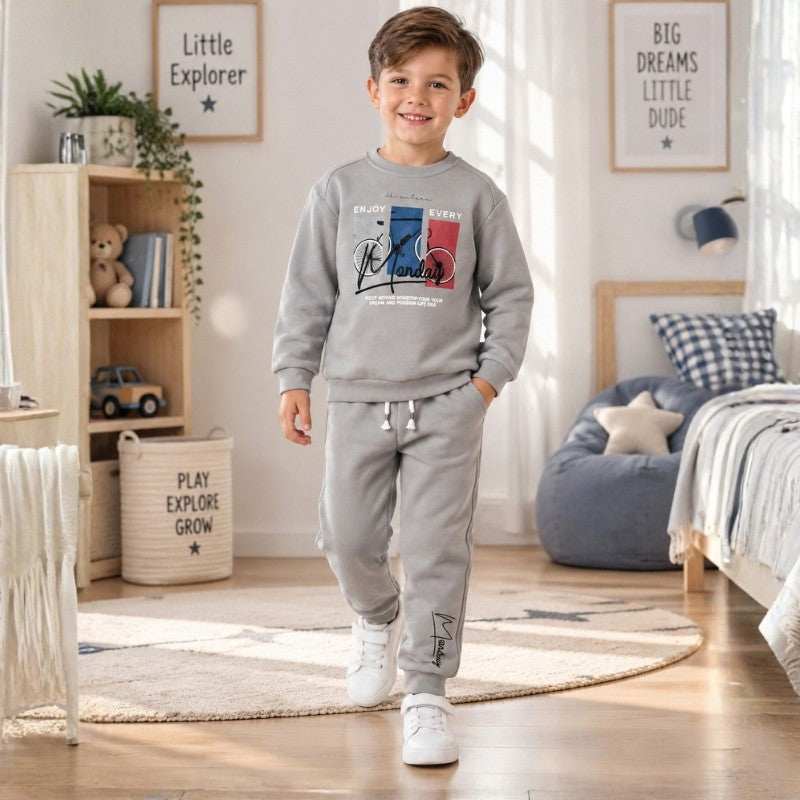 Young boy wearing a Grey sweatshirt with graphic print and matching jogger pants, a comfortable kids tracksuit set