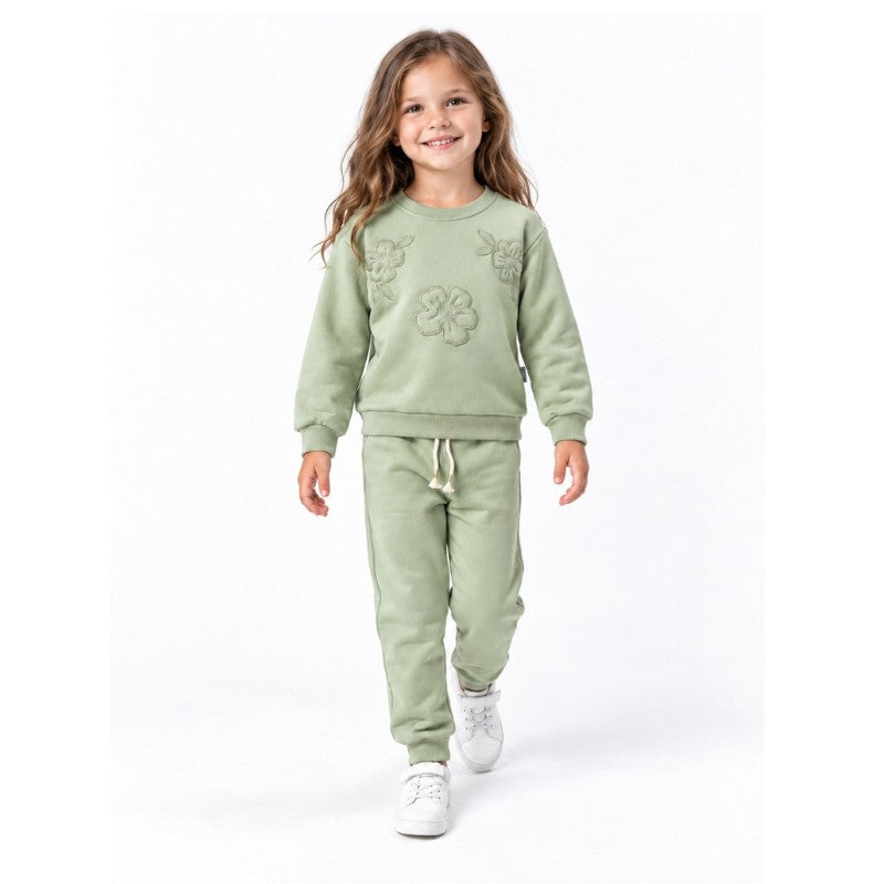 Girl wearing a mint sweatshirt and matching jogger pants, a comfortable casual tracksuit outfit for children