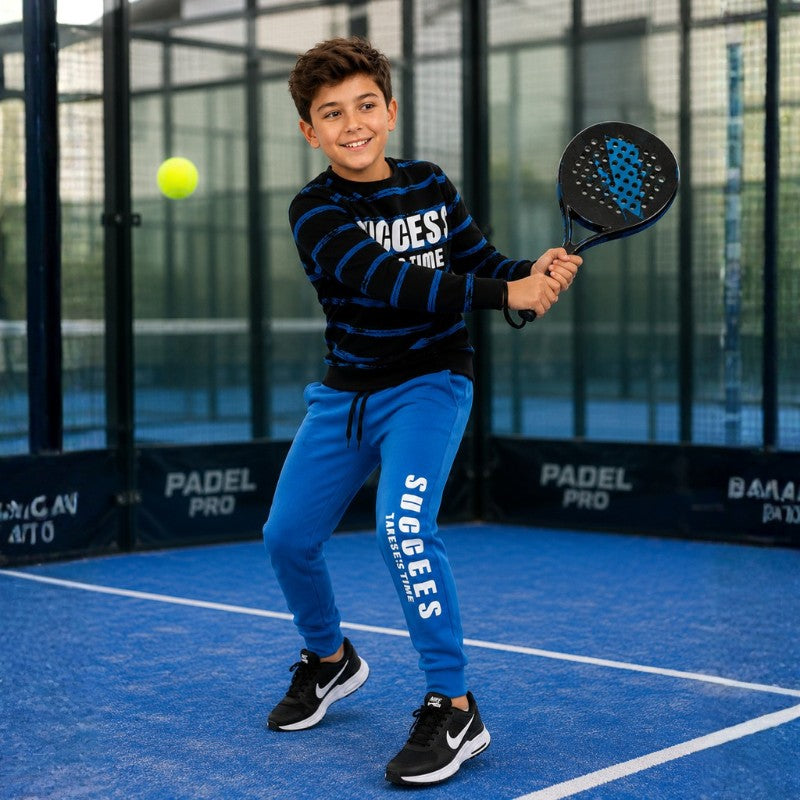 Boy wearing a black and blue Success graphic sweatshirt with matching blue jogger pants