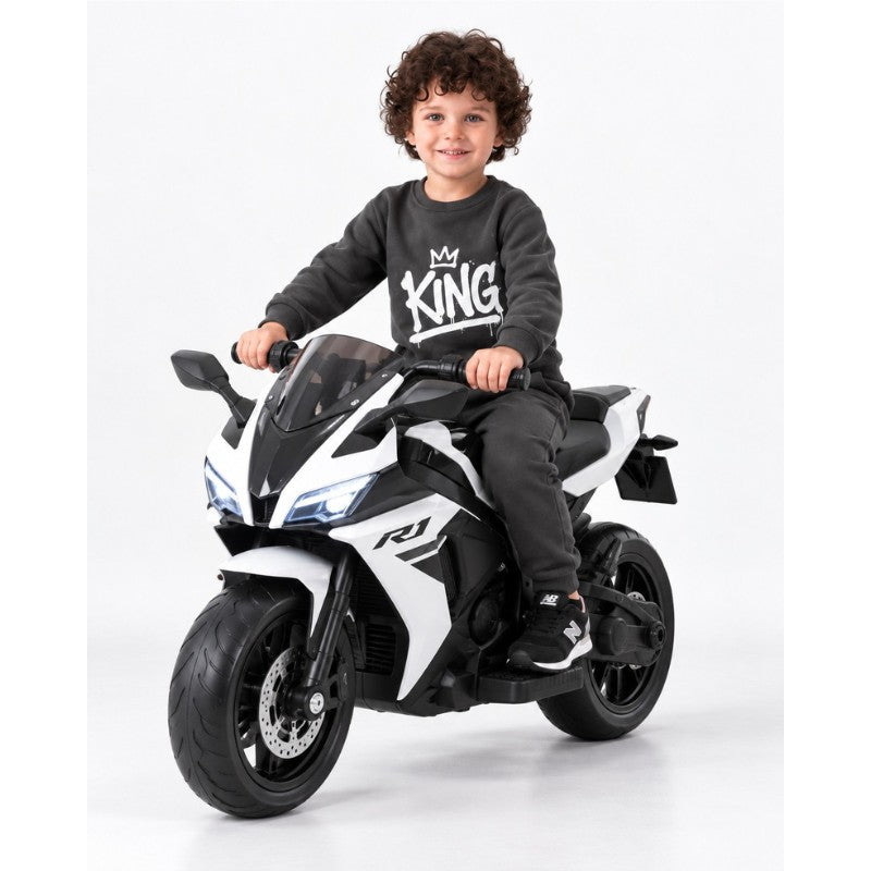 Young boy wearing a King graphic sweatshirt with matching jogger pants, a trendy kids casual tracksuit outfit