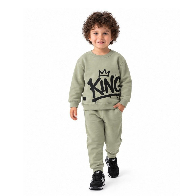 Young boy wearing a King graphic sweatshirt with matching jogger pants, a trendy kids casual tracksuit outfit