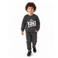 Young boy wearing a King graphic sweatshirt with matching jogger pants, a trendy kids casual tracksuit outfit
