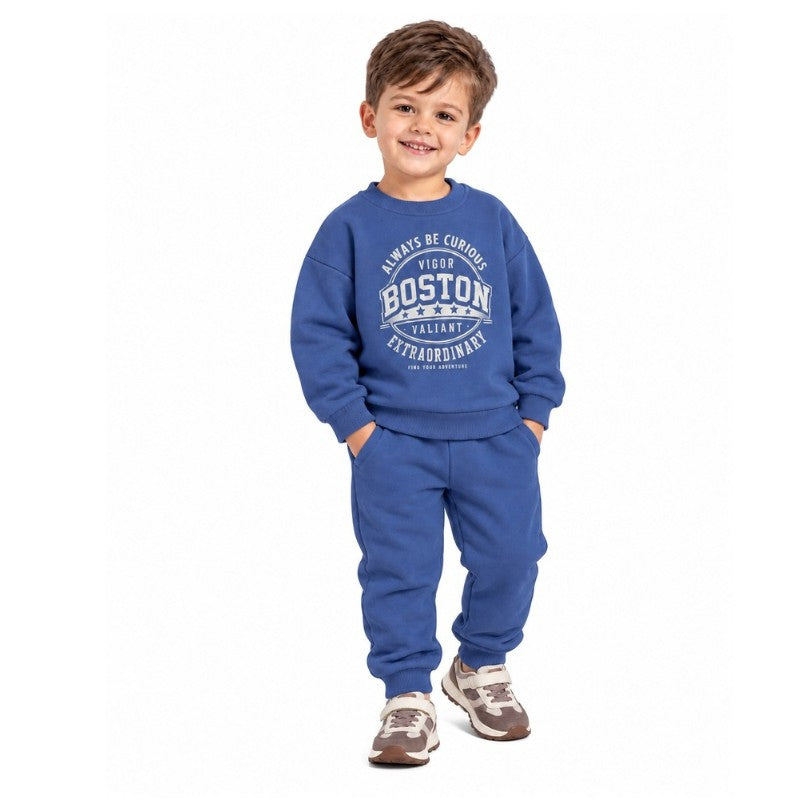 Young boy wearing a blue Boston graphic sweatshirt with matching jogger pants, a comfortable kids casual tracksuit for outdoor play