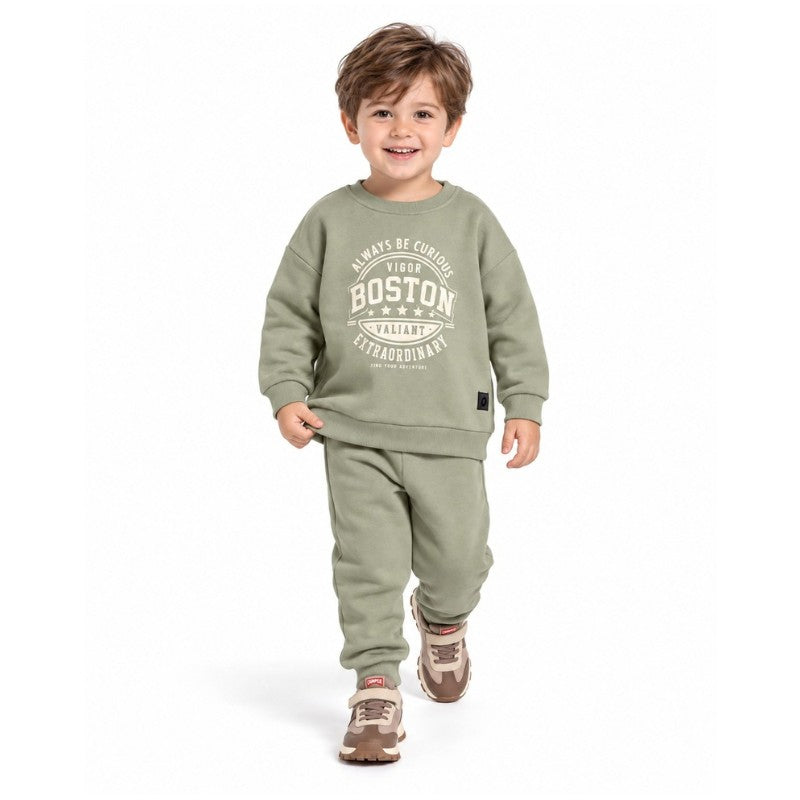 Young boy wearing a mint Boston graphic sweatshirt with matching jogger pants, a comfortable kids casual tracksuit for outdoor play