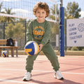 Young boy wearing a green Cool Vibes Street graphic sweatshirt with matching jogger pants, a sporty kids tracksuit for active play