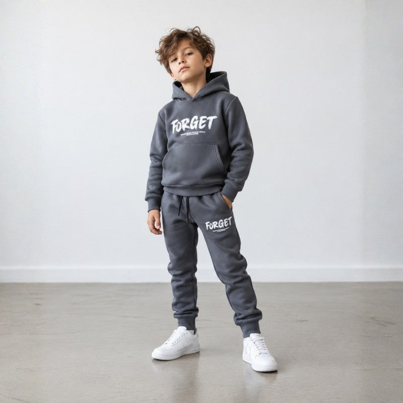 Stylish young boy wearing a grey hoodie and jogger tracksuit set 