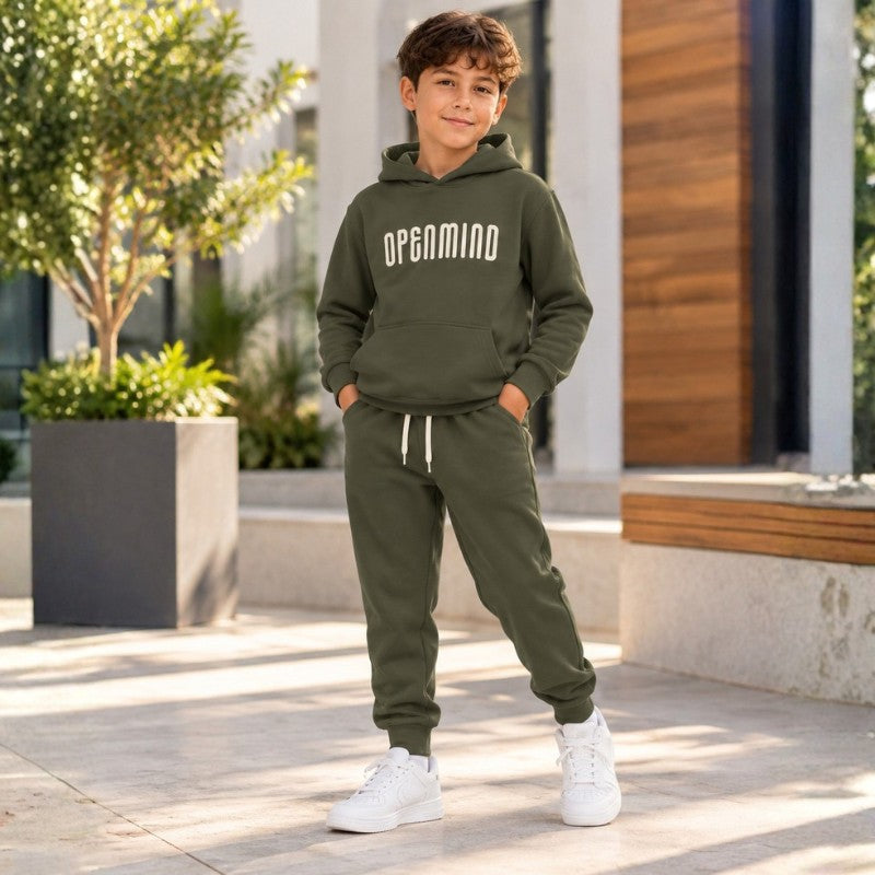 Young boy wearing a green hoodie and matching jogger pants set, stylish kids casual clothing outfit