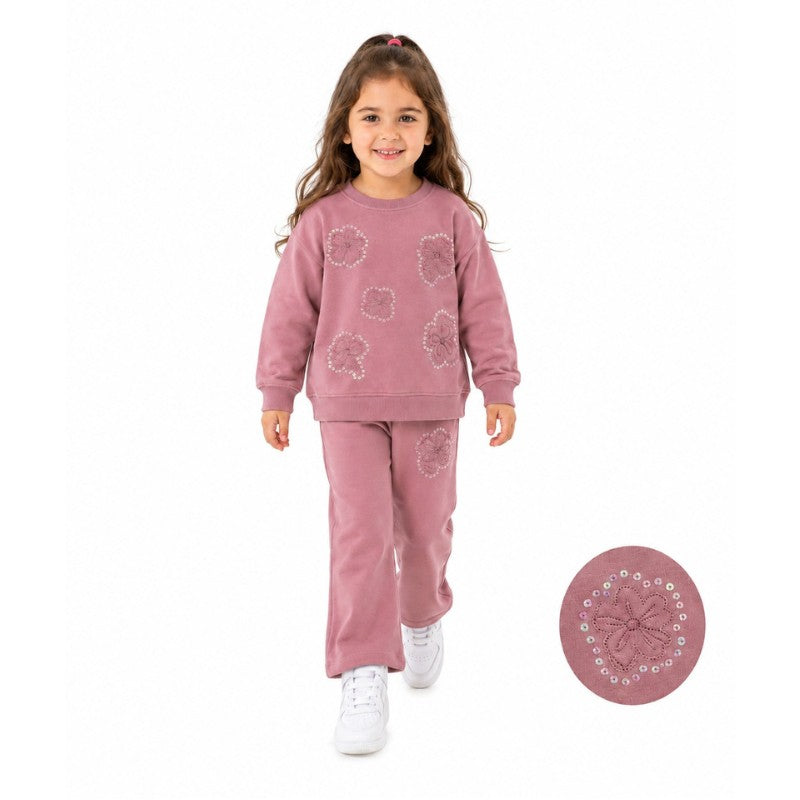Young girl wearing a floral tracksuit