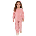 Young girl wearing a pink polka dot sweatshirt and matching pants.