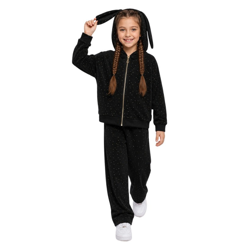 Young girl wearing a black bunny-ear hoodie tracksuit set in a pink crepe shop