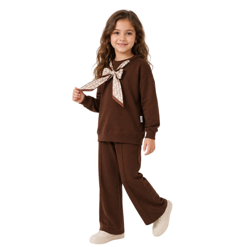 Young girl wearing a brown butterfly bow tracksuit set