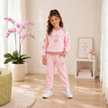 Young girl wearing a sweatshirt and matching jogger pants