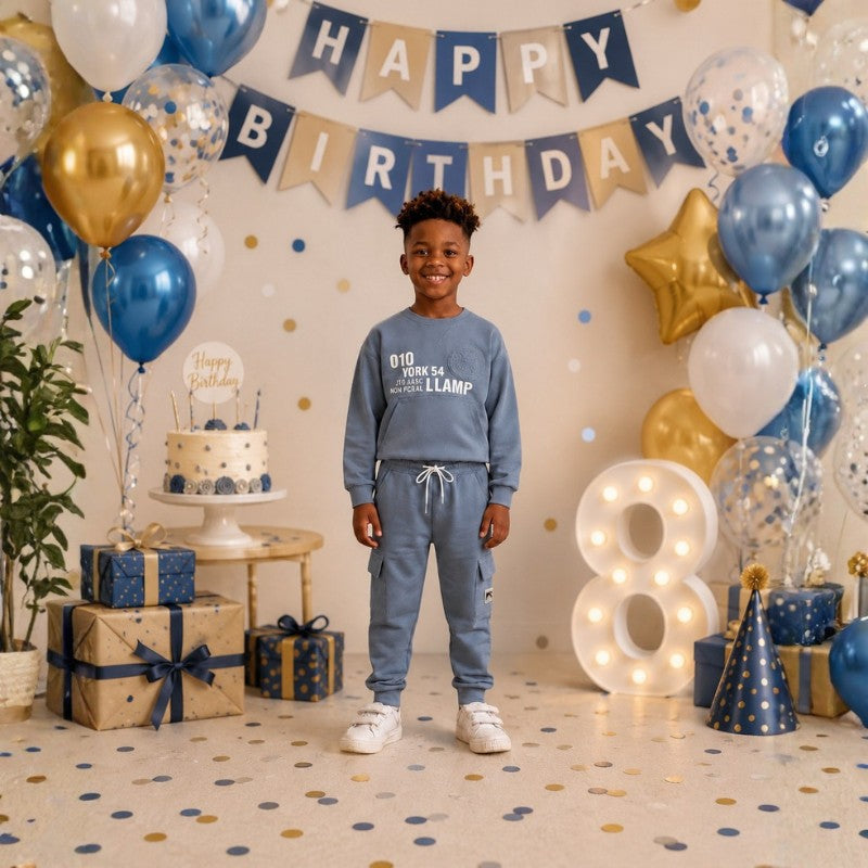 Young boy wearing a graphic sweatshirt with matching cargo jogger pants.