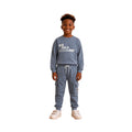 Young boy wearing a graphic sweatshirt with matching cargo jogger pants.