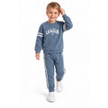 Young boy wearing a blue All-State League sweatshirt with matching striped jogger pants, stylish casual kids tracksuit