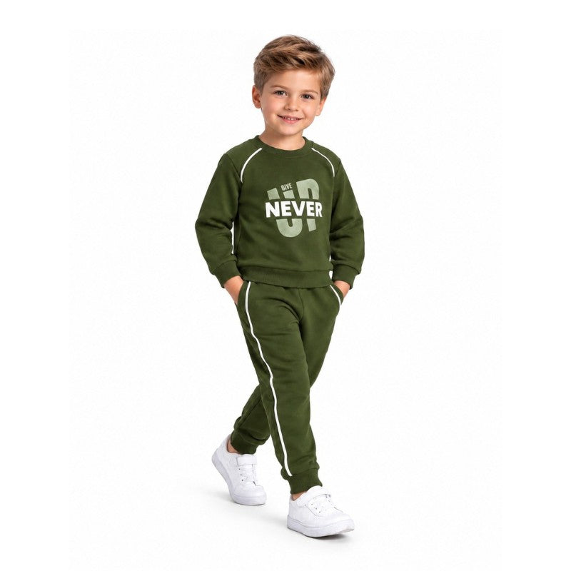 Young boy wearing a green Never Give Up sweatshirt with matching jogger pants and sporty side stripes, a casual kids tracksuit set