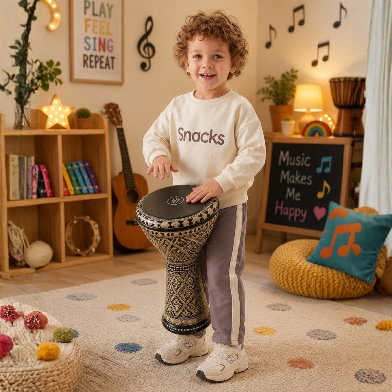 Young boy wearing a cream “Snacks” sweatshirt and pants with white side stripes
