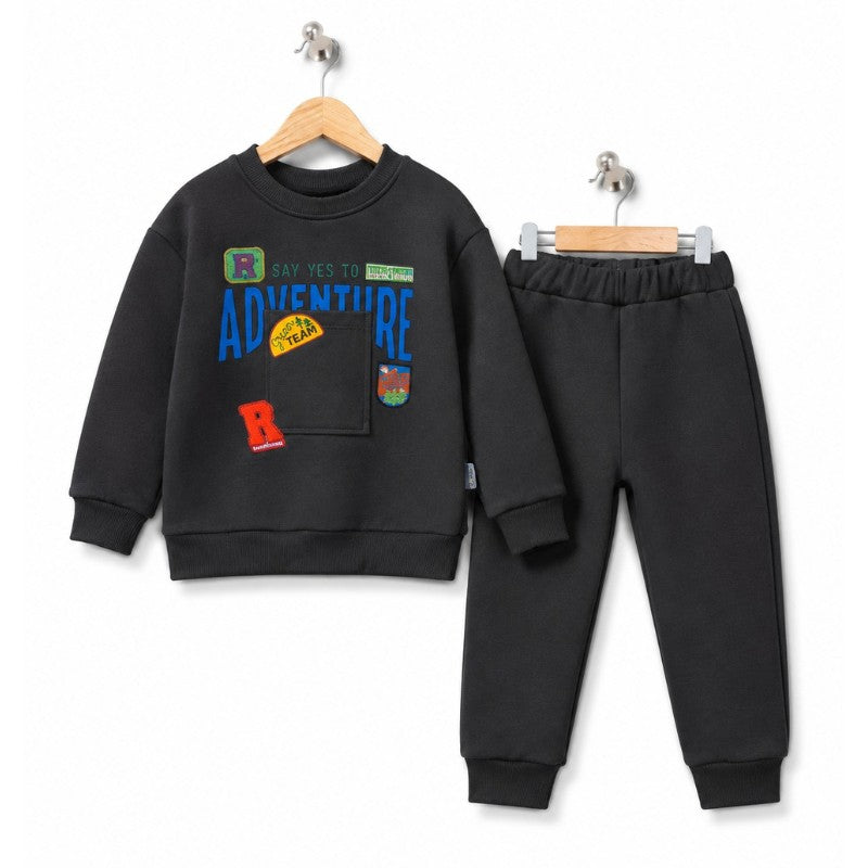 Young boy wearing a grey adventure sweatshirt