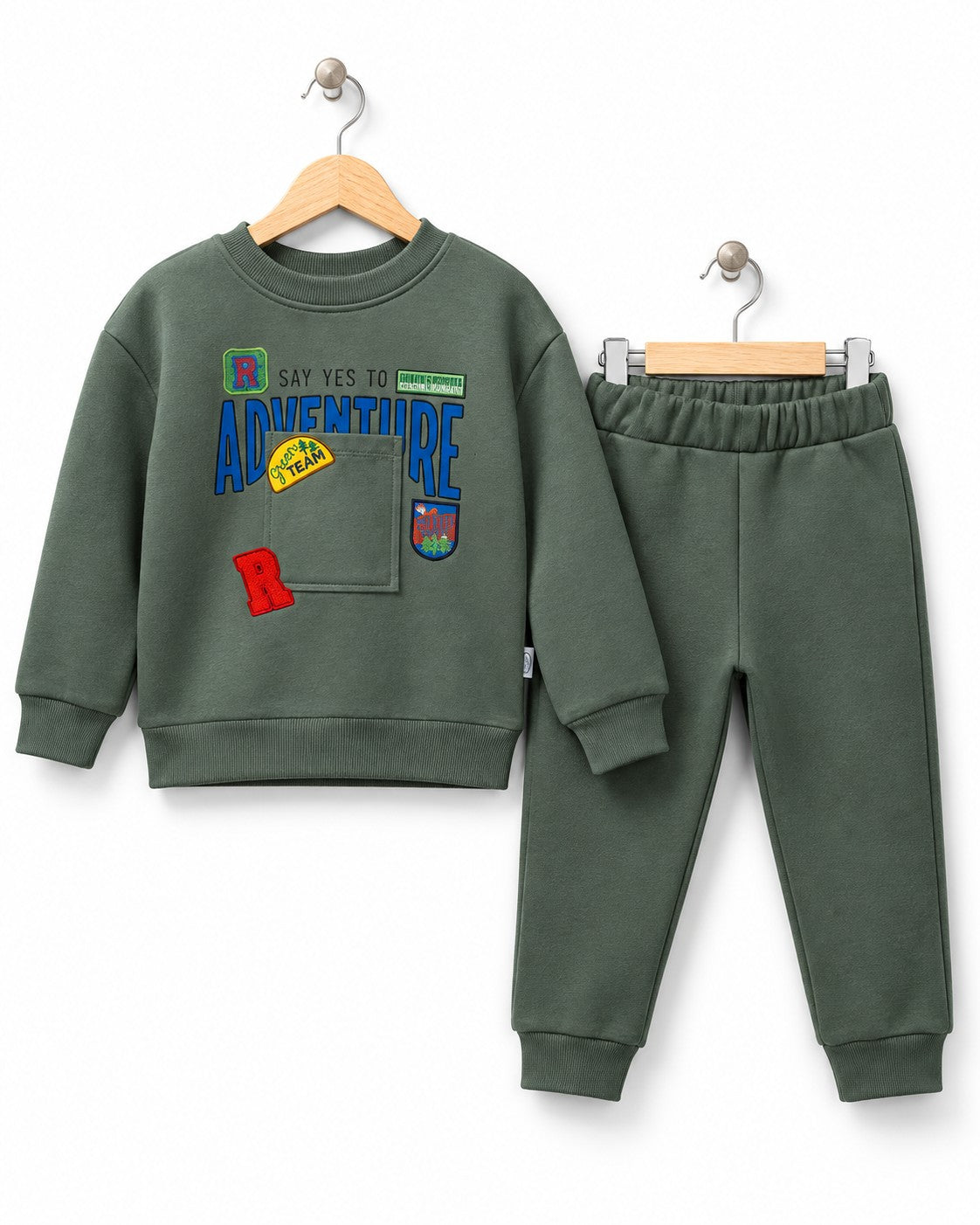 Young boy wearing a green adventure sweatshirt 