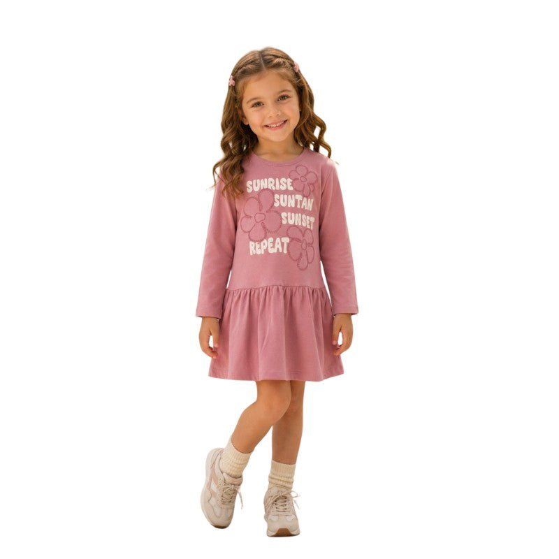 Young girl wearing a long sleeve dress with a floral graphic print 