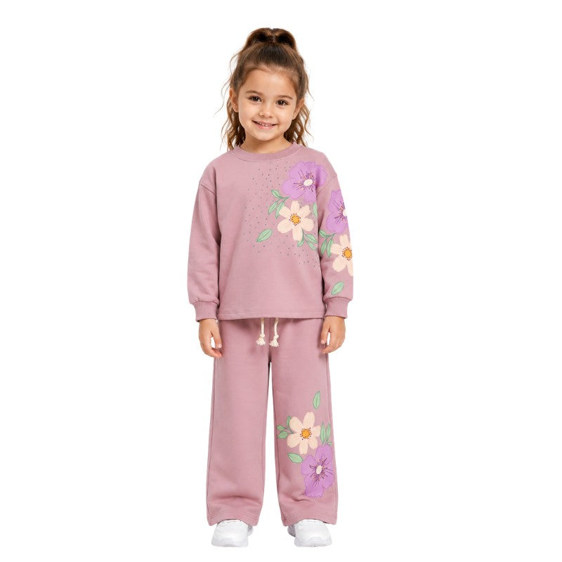 Young girl wearing a floral tracksuit set