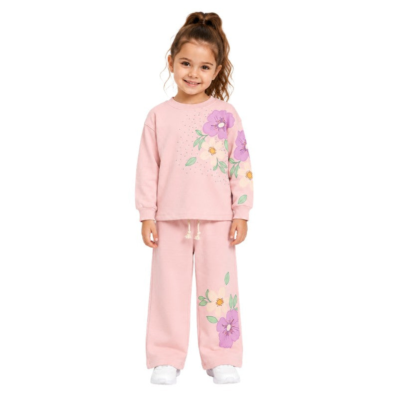 Young girl wearing a floral tracksuit set