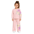 Young girl wearing a floral tracksuit set