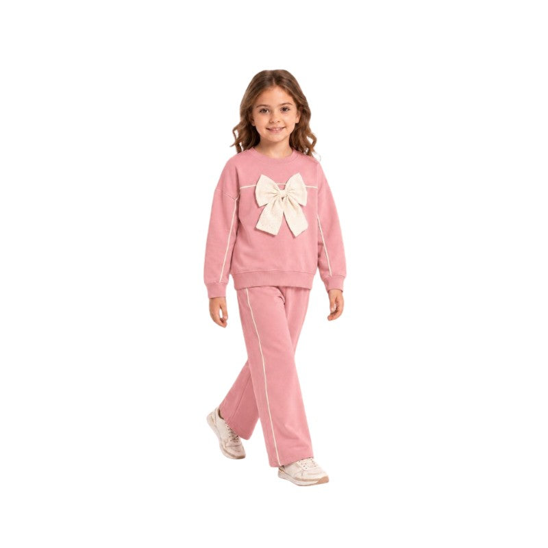 Girl wearing a pink sweatshirt with an oversized bow and matching wide-leg pants, stylish children's two-piece casual outfit