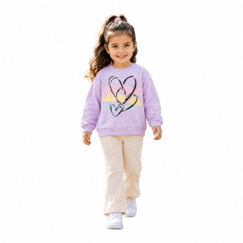 Young girl wearing a lila heart-print sweatshirt and cream pants