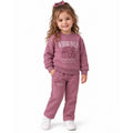 Young girl wearing a pink sweatshirt and matching jogger set