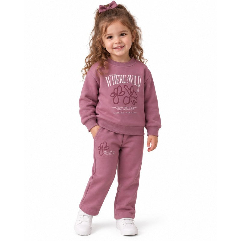 Young girl wearing a pink sweatshirt and matching jogger set