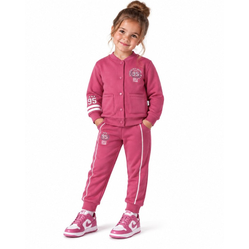 Young girl wearing a varsity jacket with number 95 graphics and matching striped jogger trousers