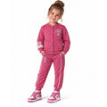 Young girl wearing a varsity jacket with number 95 graphics and matching striped jogger trousers